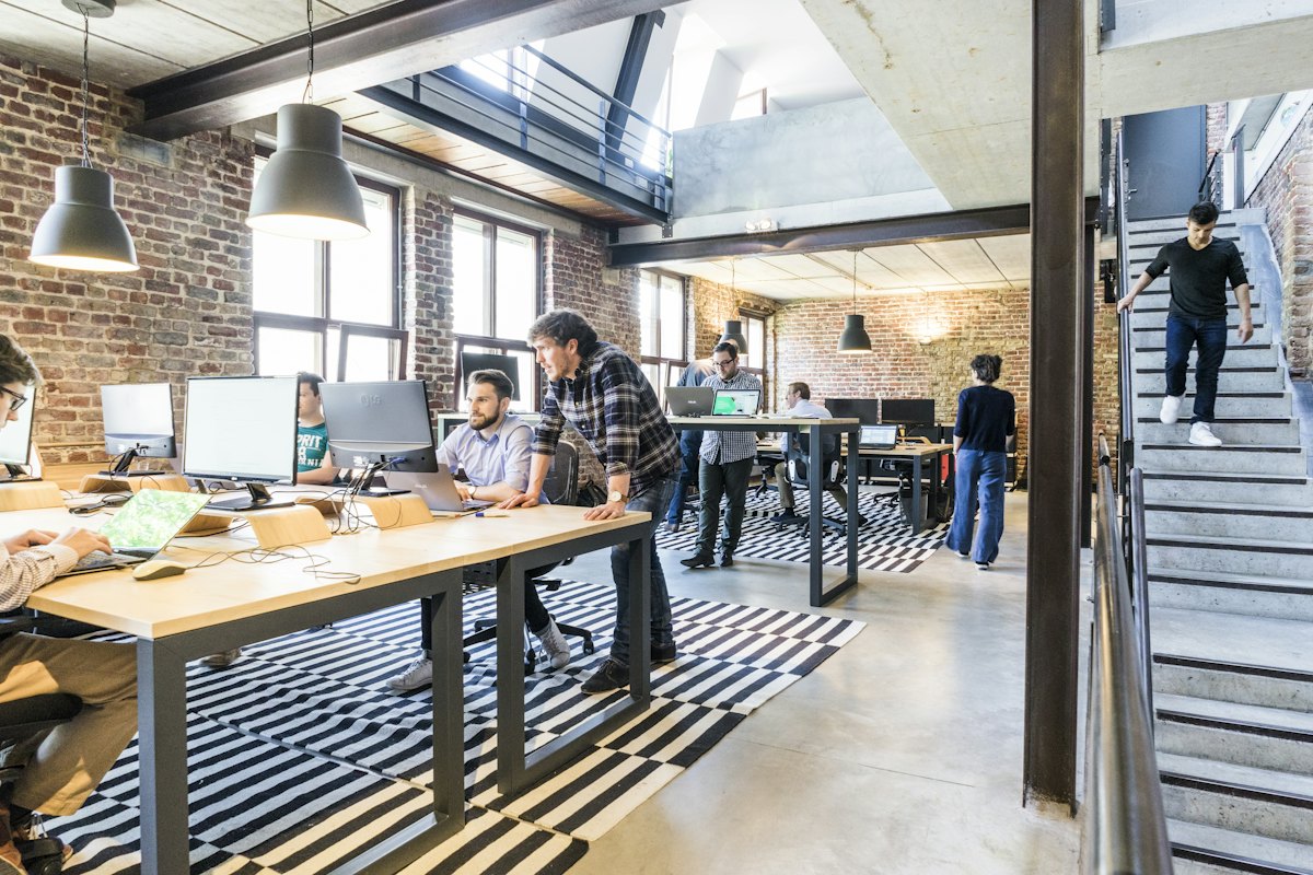 People using phones and laptops to search for local businesses